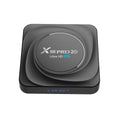 Android set-top TV box with remote control on a wooden surface