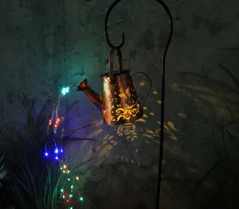 Solar garden lamp with tapered iron butterfly design and warm white LED light.