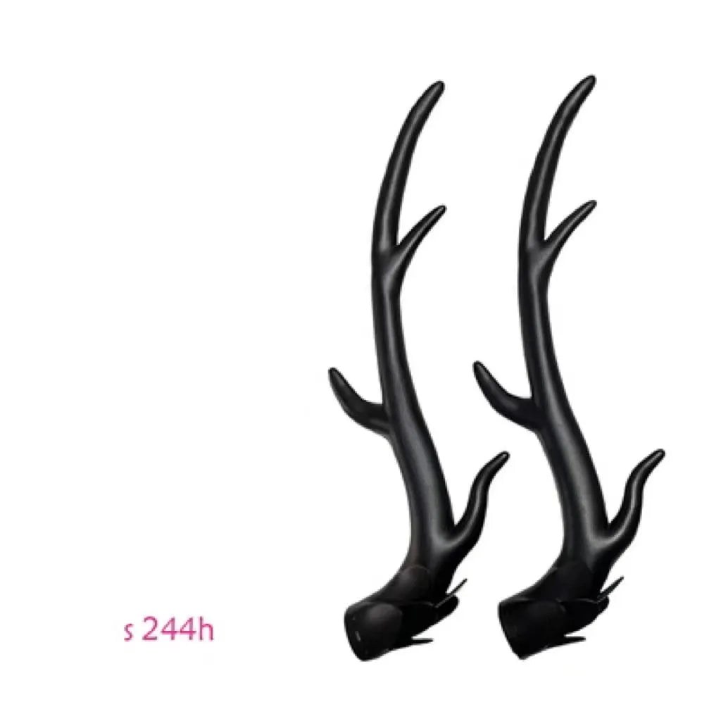 A pair of black resin dragon horn decorations for motorcycle helmets, showing curved shape and textured surface.