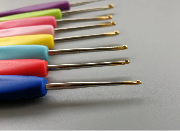 Set of 16 crochet hooks with different coloured handles in a grey PU storage bag