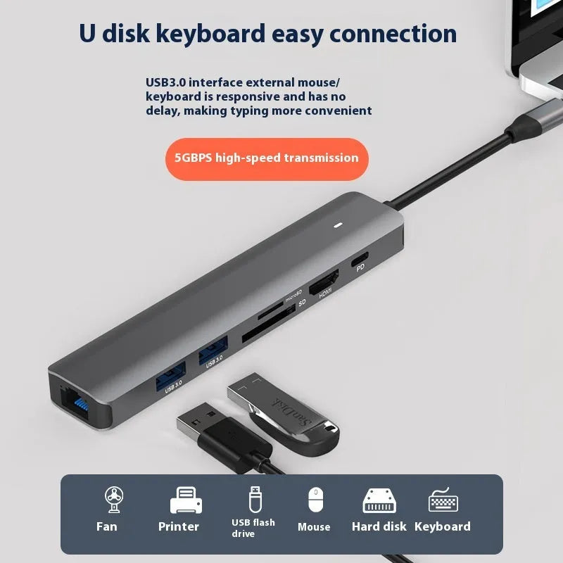LQT-LH07 7-in-1 card reader and USB-C PD computer hub on a desk next to a laptop.