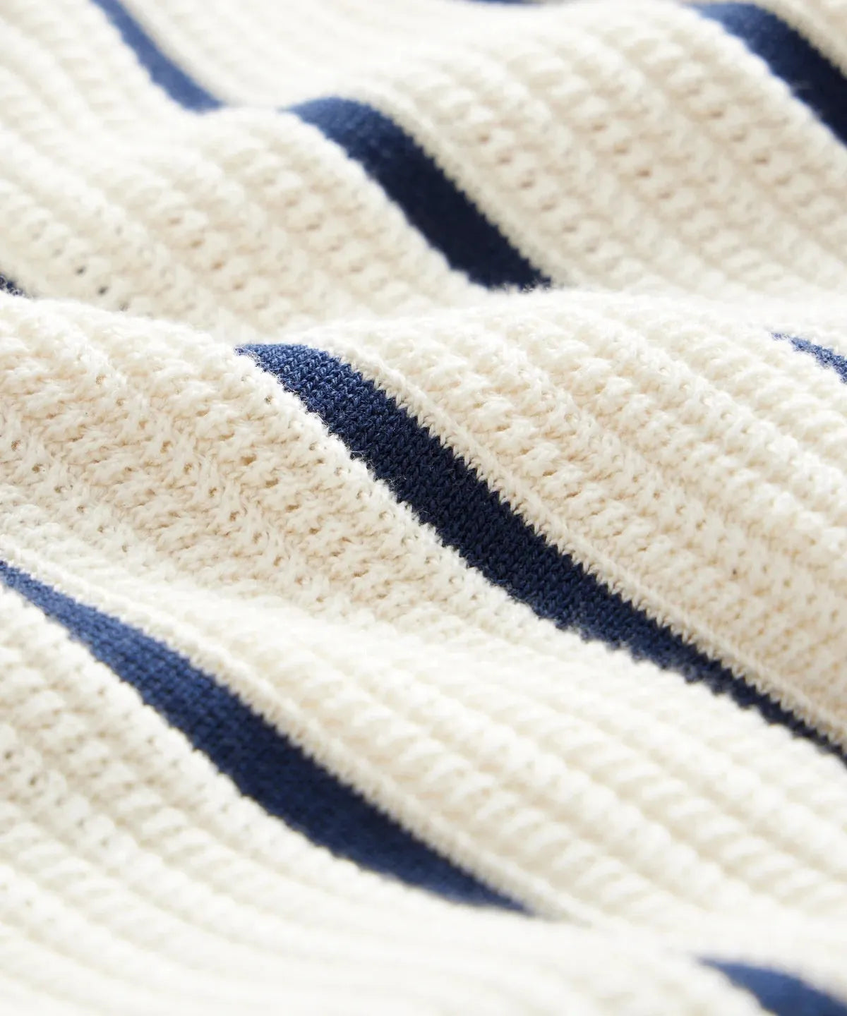 White men's short sleeve knitted shirt with asymmetric stripes and a lapel collar.