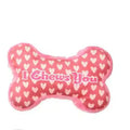 Plush dog chew toy with squeaker in bone pink colour on a white background