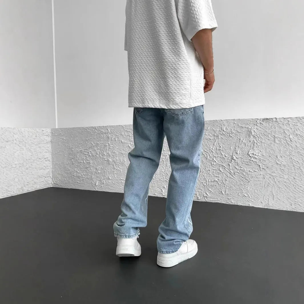 Men's blue straight-leg jeans with loose wide-leg fit and mid-rise waist