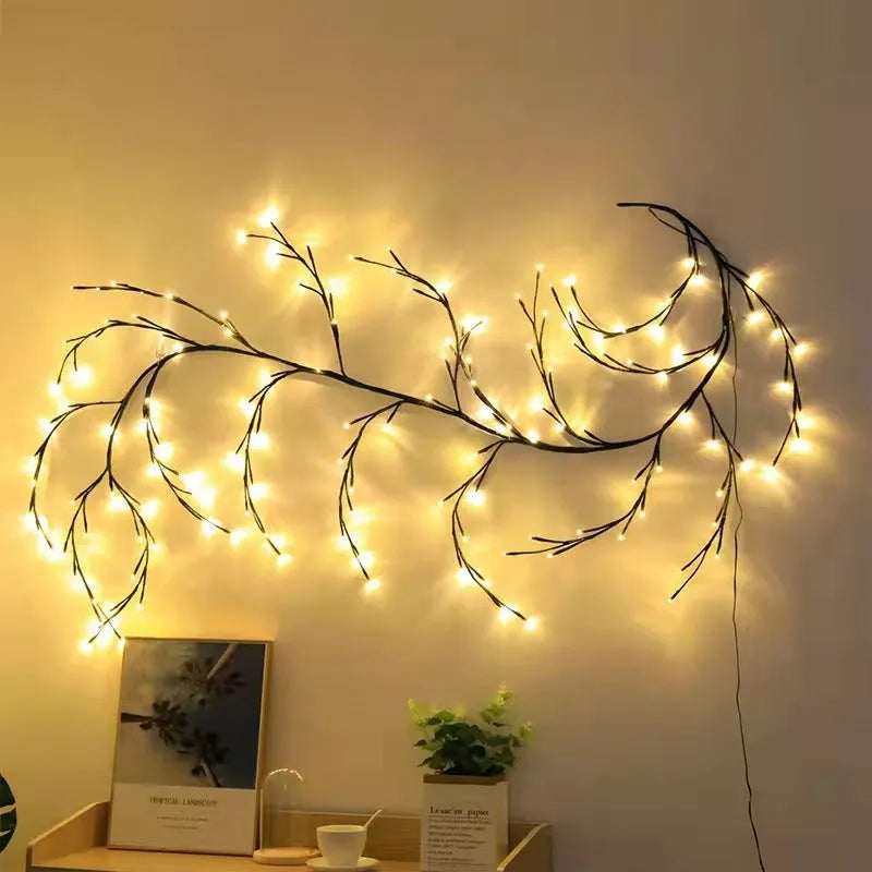 Flexible plastic willow vine LED garland light with warm white bulbs and birch bark texture.