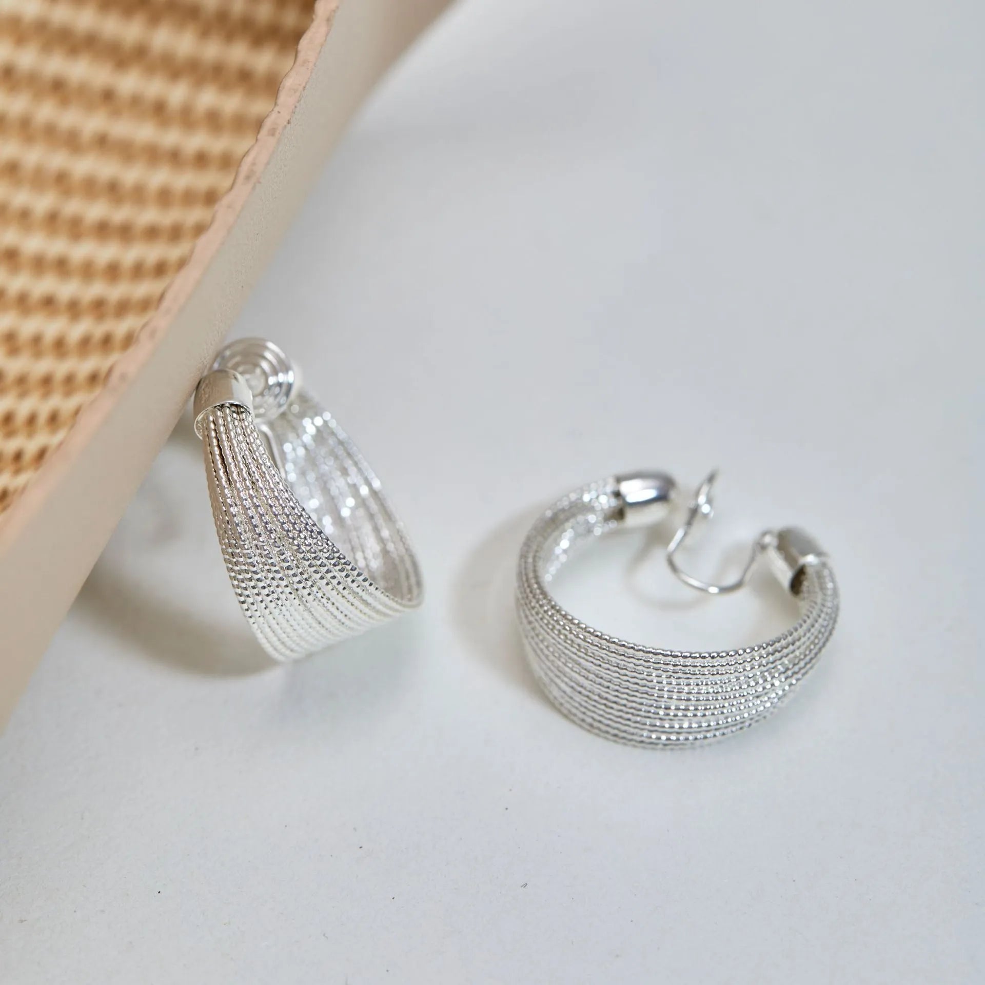 Simple geometric bracelet earrings with clip and stud backs in silver or gold colour.