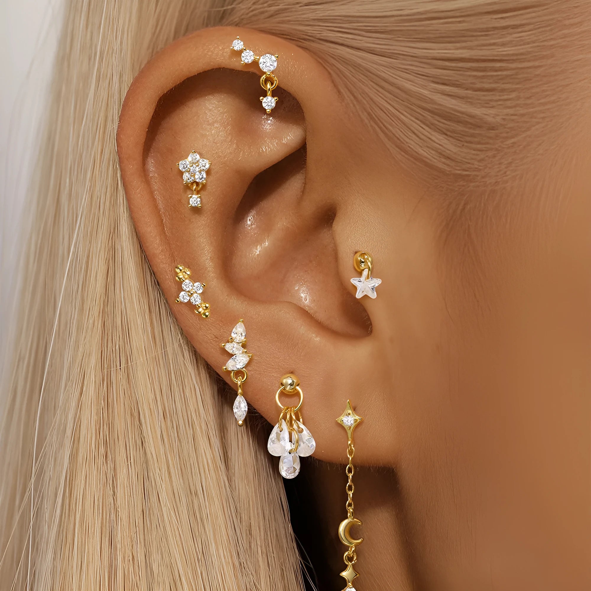 S925 sterling silver geometric moon earring with embedded star design in a gold colour.