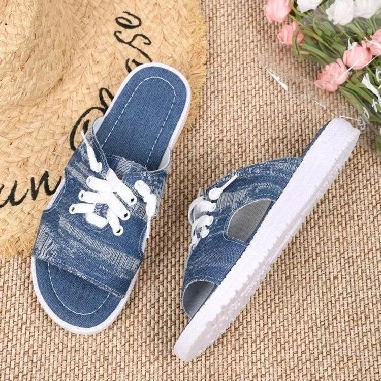 Blue Roman style women's flat canvas slippers with cloth upper and rubber sole.