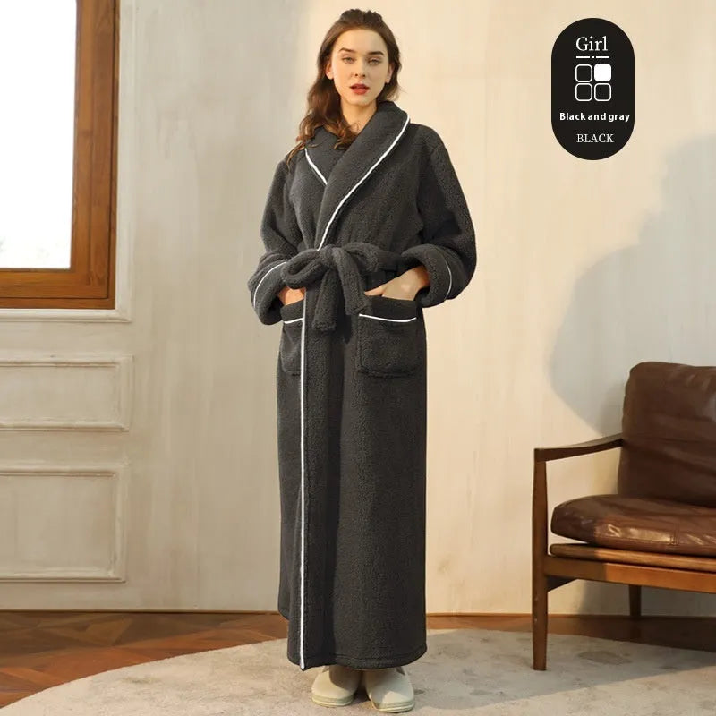 A man and woman wearing matching navy blue thick flannel bathrobes, showcasing the wrap-around design and plush fabric.
