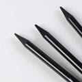 Wooden case containing six graphite pencils and three carbonized pencils for drawing, presented on a white suction card.