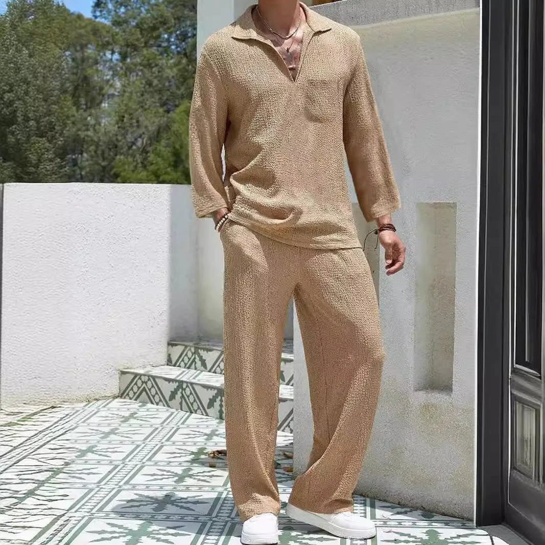 Man wearing a casual lake blue polyester shirt and matching trousers from a two-piece suit set.