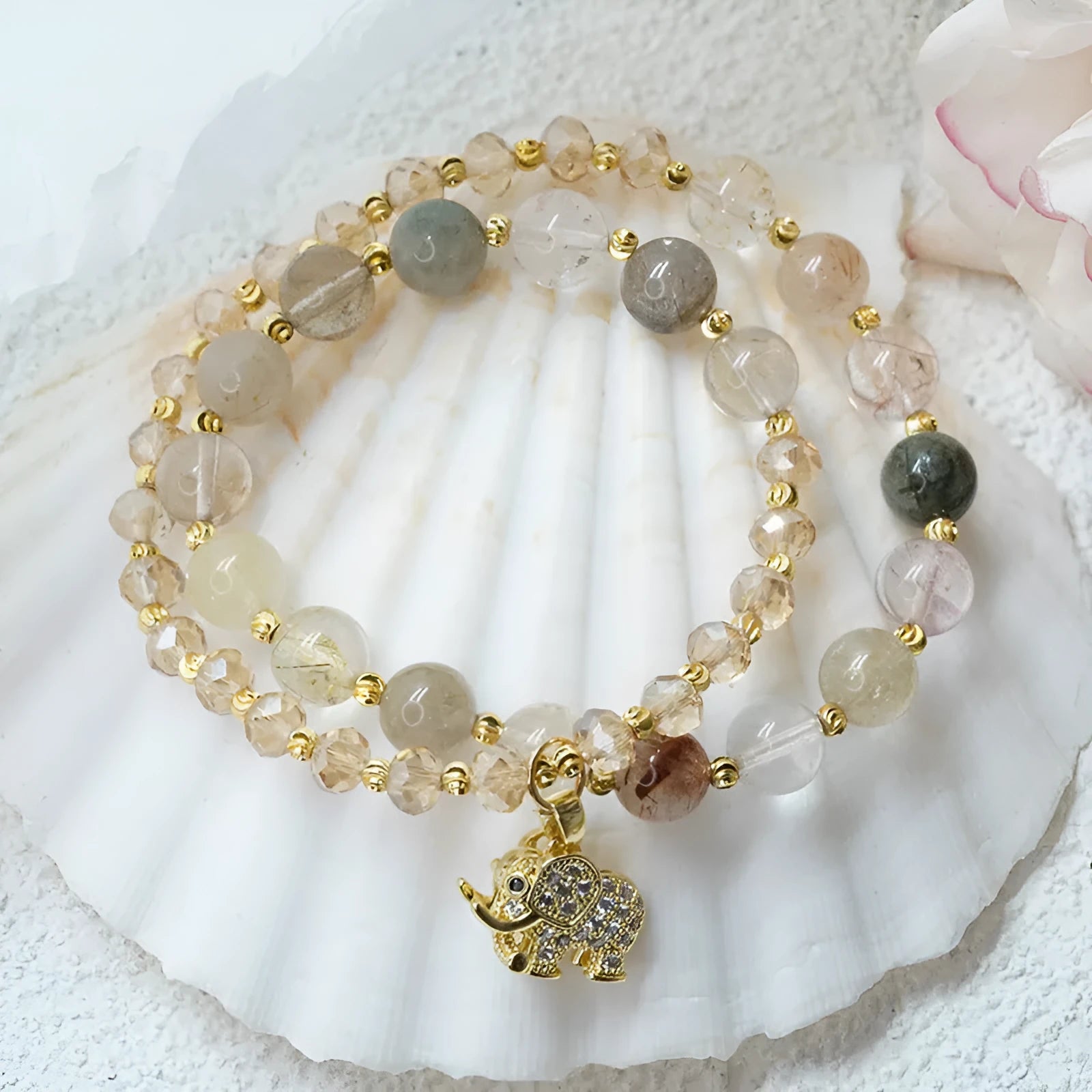 Retro style women's bracelet with colour hair crystal or strawberry quartz beads on a wrist.