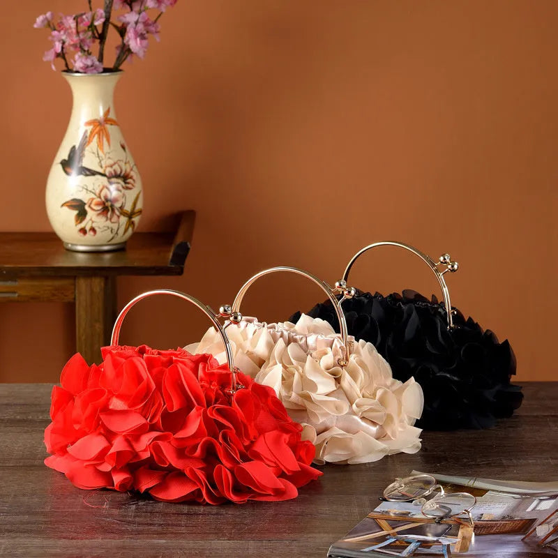 Handheld ladies' polyester banquet bag in soft dumpling shape with flower detail, black colour