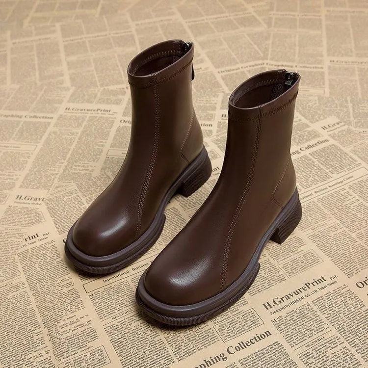 Women's black flat heel ankle boots with a back zipper and round toe