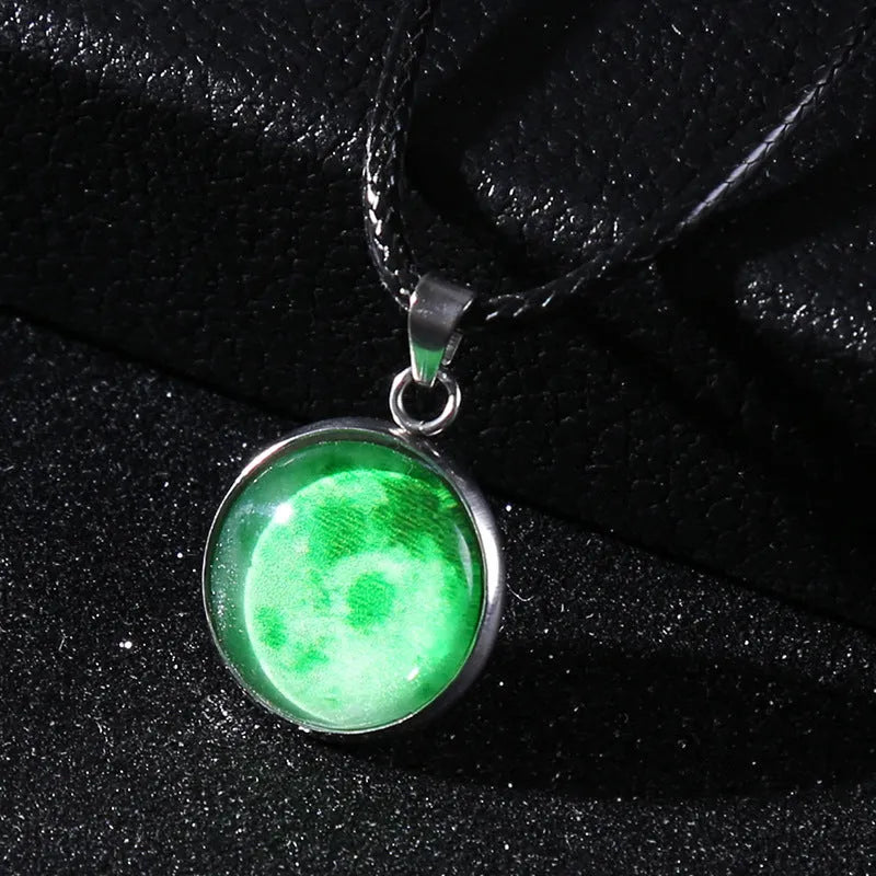 Luminous moon and star constellation pendant necklace with a silver-tone chain on a black background.
