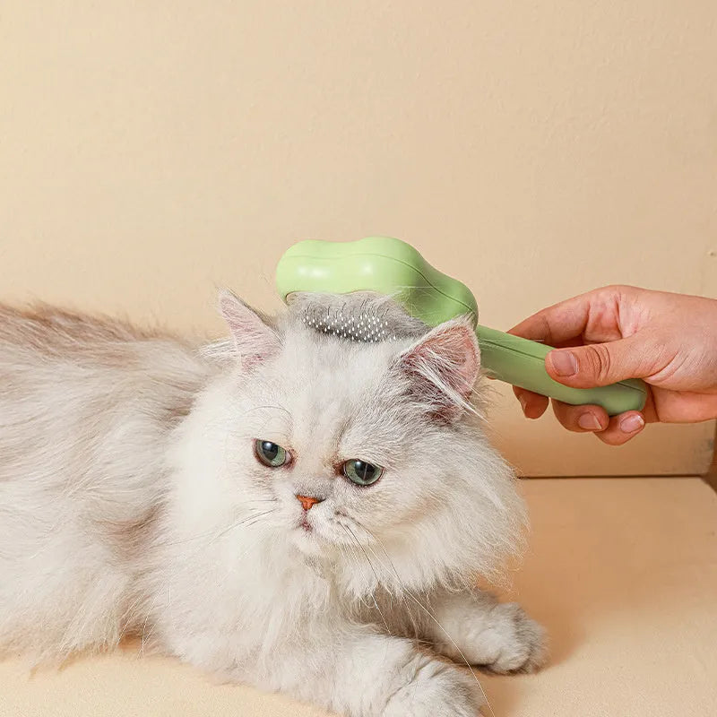 Green self-cleaning cat grooming comb with stainless steel needles and wand handle
