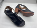 Women's white peep toe wedge sandals with a buckle strap on a slingback heel.