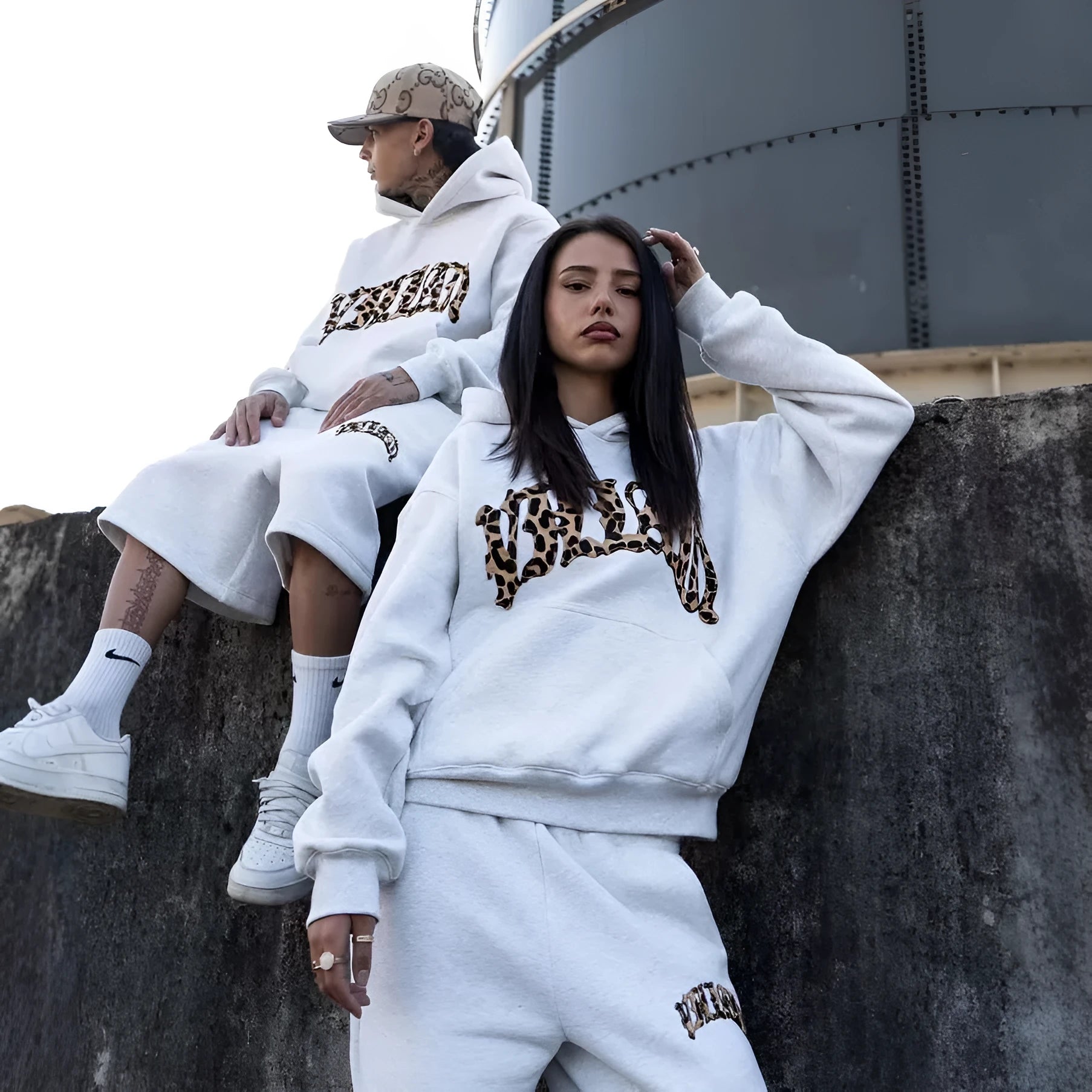 Men's patchwork loose trousers with a double waistband and zip fly, shown in streetwear style.