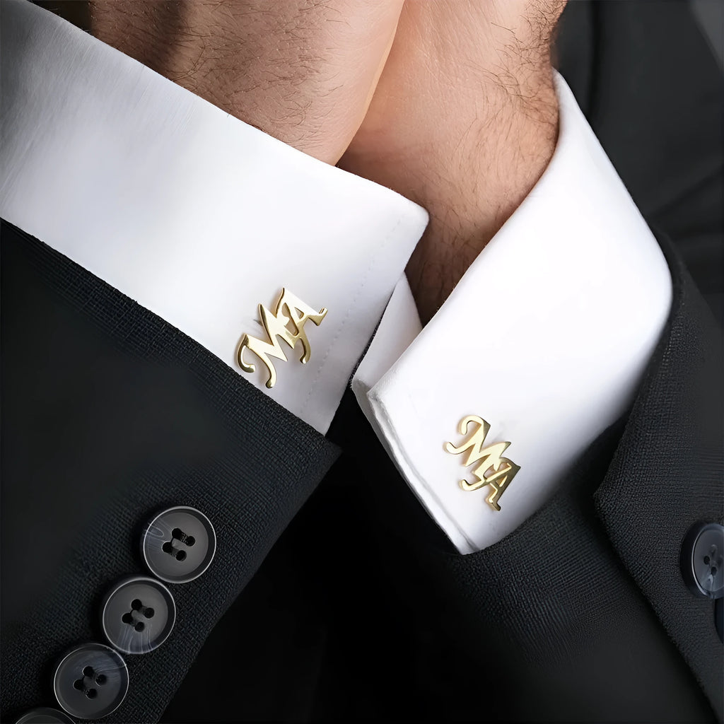 Handmade frosted personalised name abbreviation metal cufflinks in gold colour on a grey background