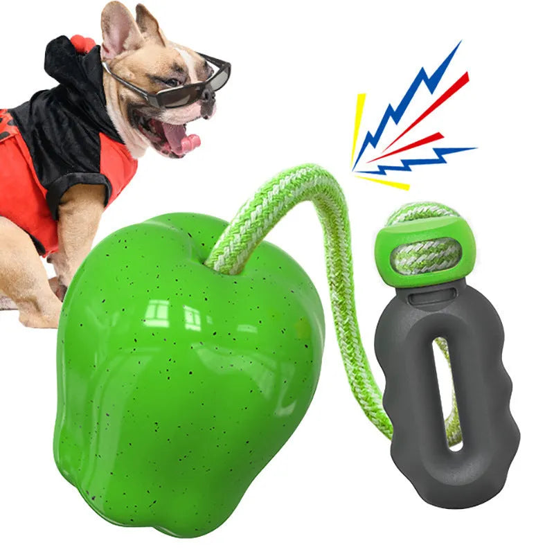 Green and red plastic dog toy ball with squeaky sound and molar texture for outdoor play