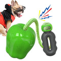 Green and red plastic dog toy ball with squeaky sound and molar texture for outdoor play