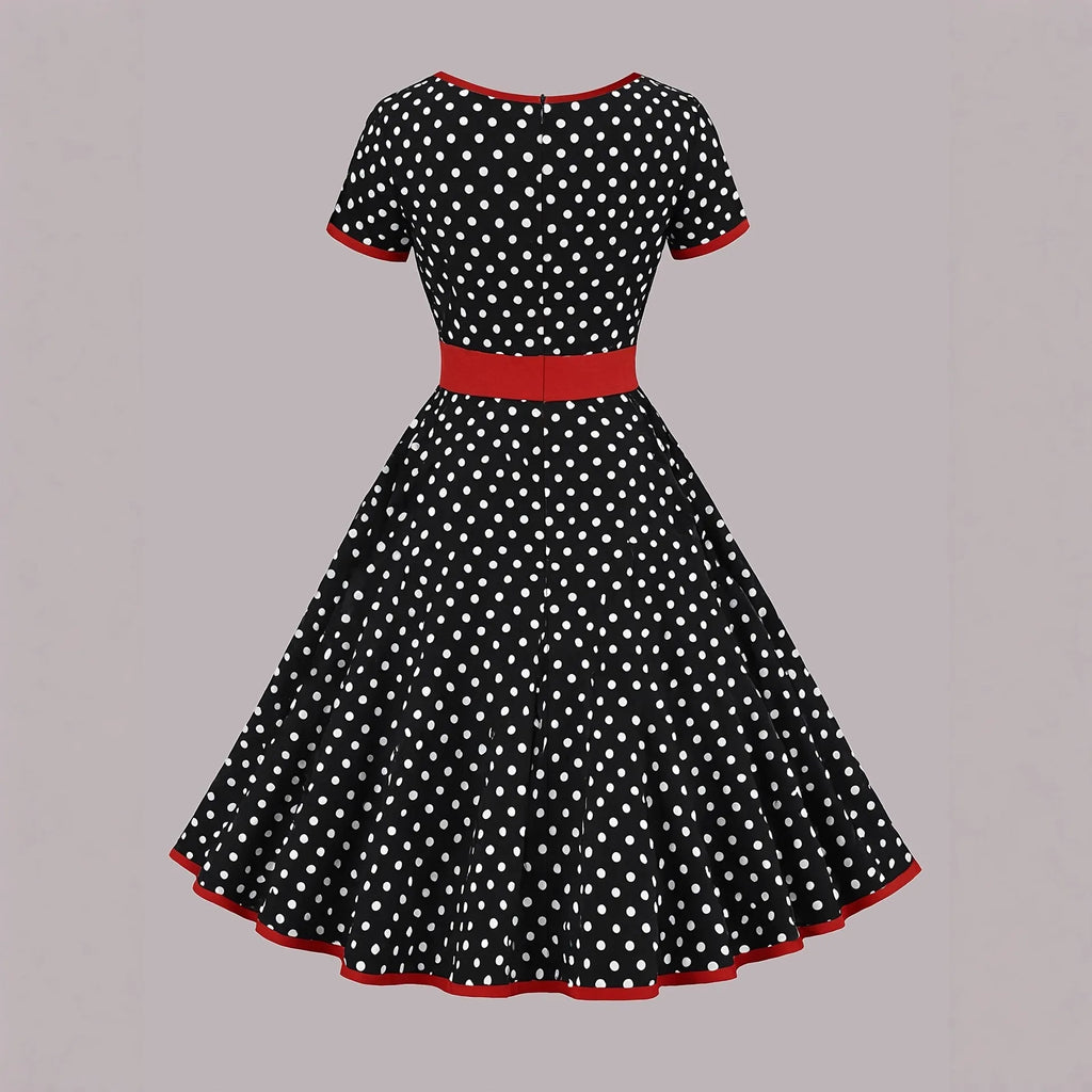 Multicolour polka dot dress with square collar, short sleeves, front zipper, and pleated midi skirt on a hanger.