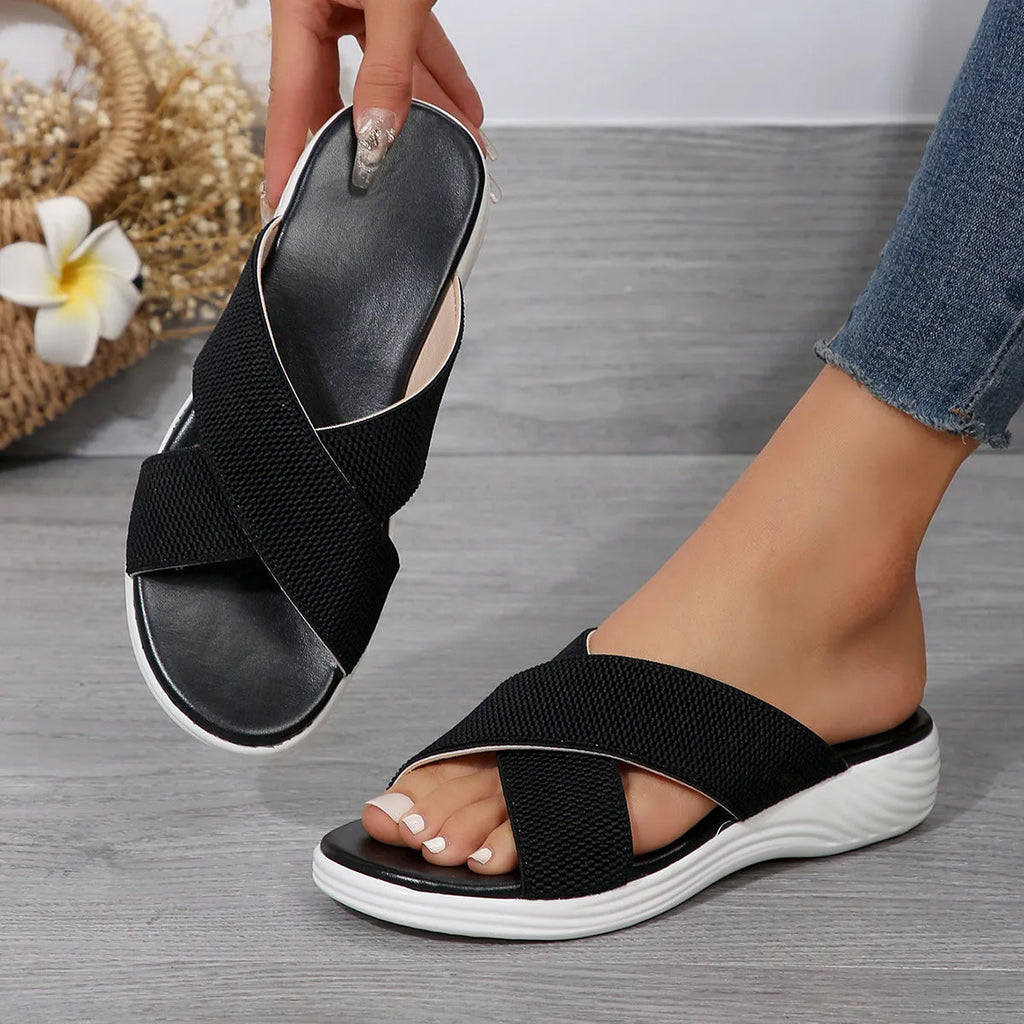 Women's black wedge slippers with peep-toe and cross-strap on thick rubber sole