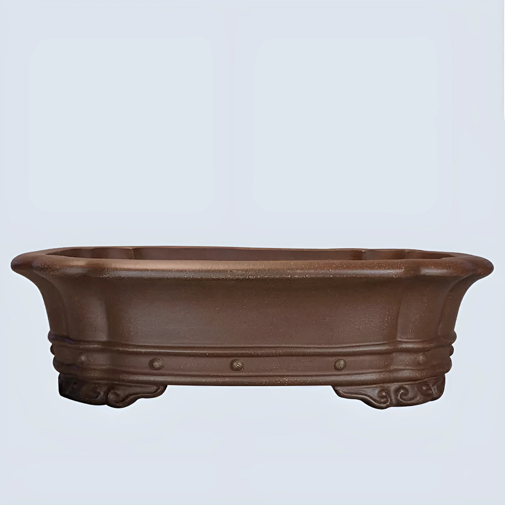 Handmade purple sand rectangular antique begonia flower pot on a desktop.
