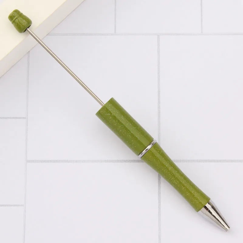 Colourful spinning ballpoint pen with plastic beads on a white background.