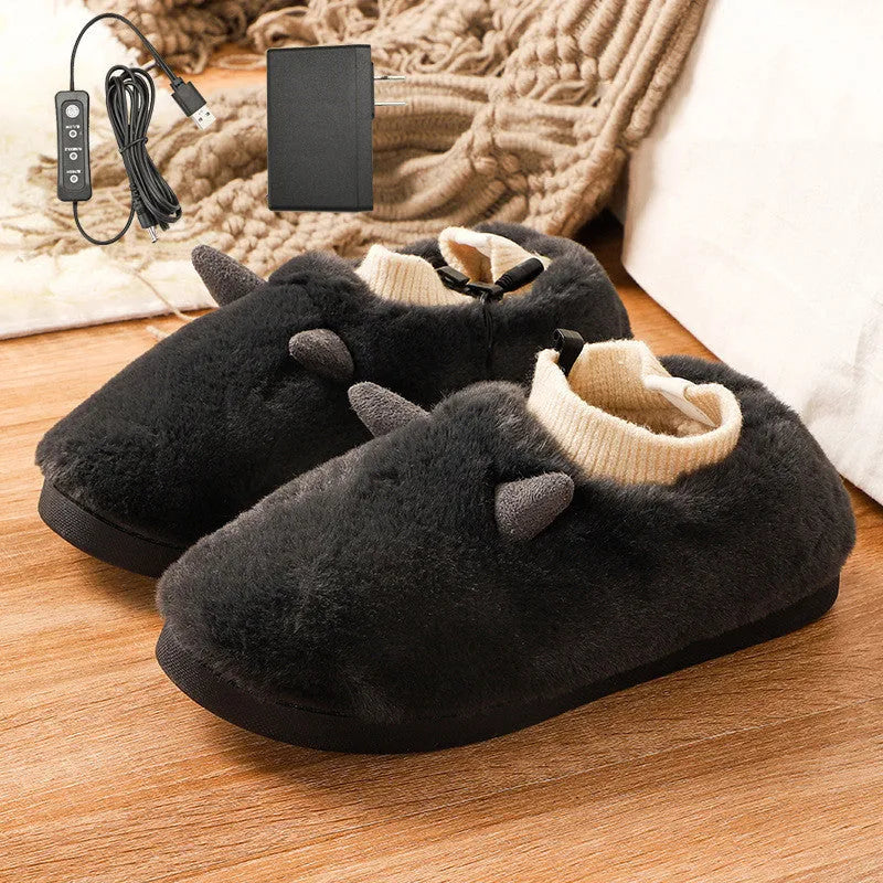 USB electric foot warmer slippers in grey with a connected USB cable on a wooden floor.