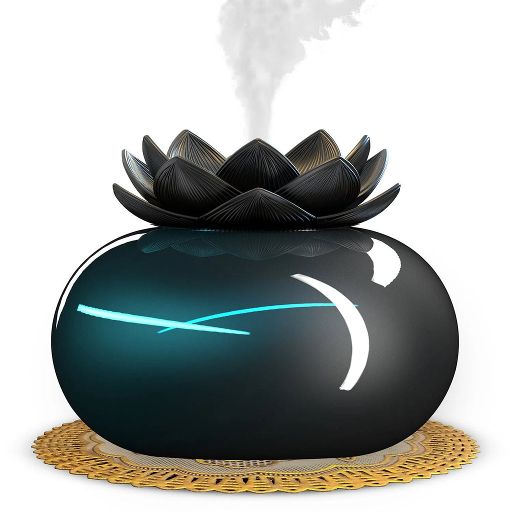 Pure black round Lotus aromatherapy ultrasonic humidifier with USB cable on a desk.