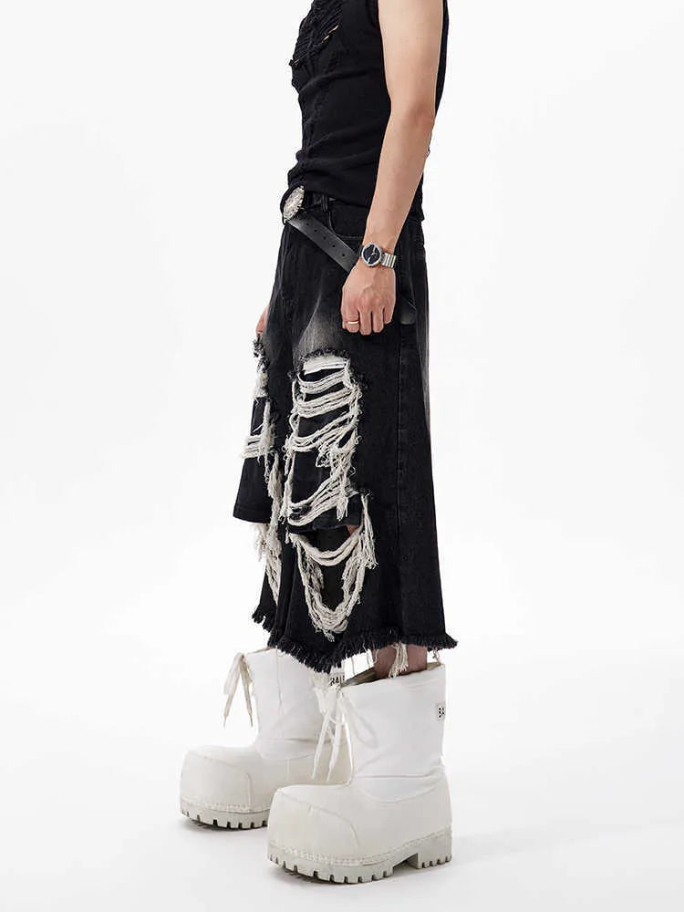 Black cropped wide-leg women's jeans with a ripped patch detail and a mid-high waist.