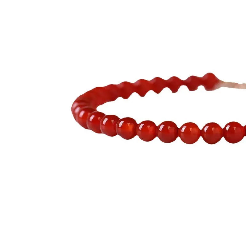 Ultra-thin red agate bracelet for women on a white background.