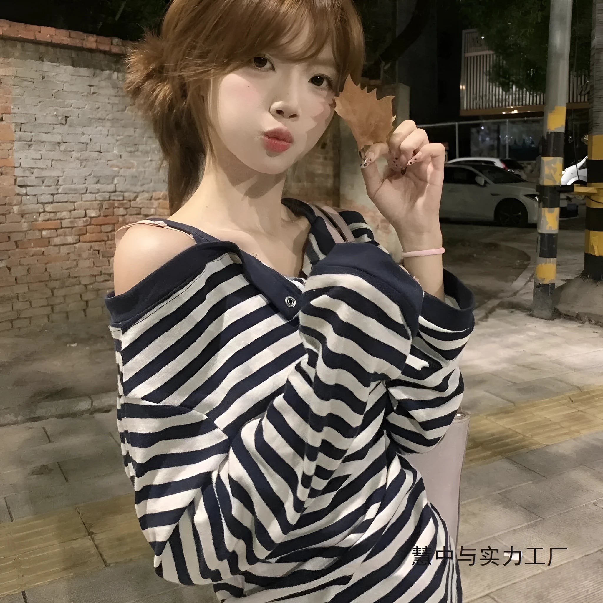 Dark blue oversized long-sleeved women's T-shirt with stripes and embroidery details.