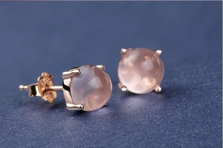 Rose gold drop shape stud earrings with crystal inlay detail on a silver base.