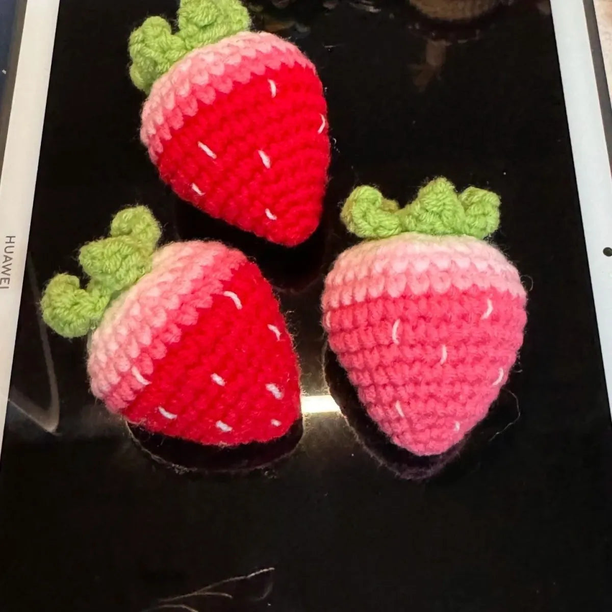 Soft plush strawberry-shaped pendant keychain in pink or red colour.