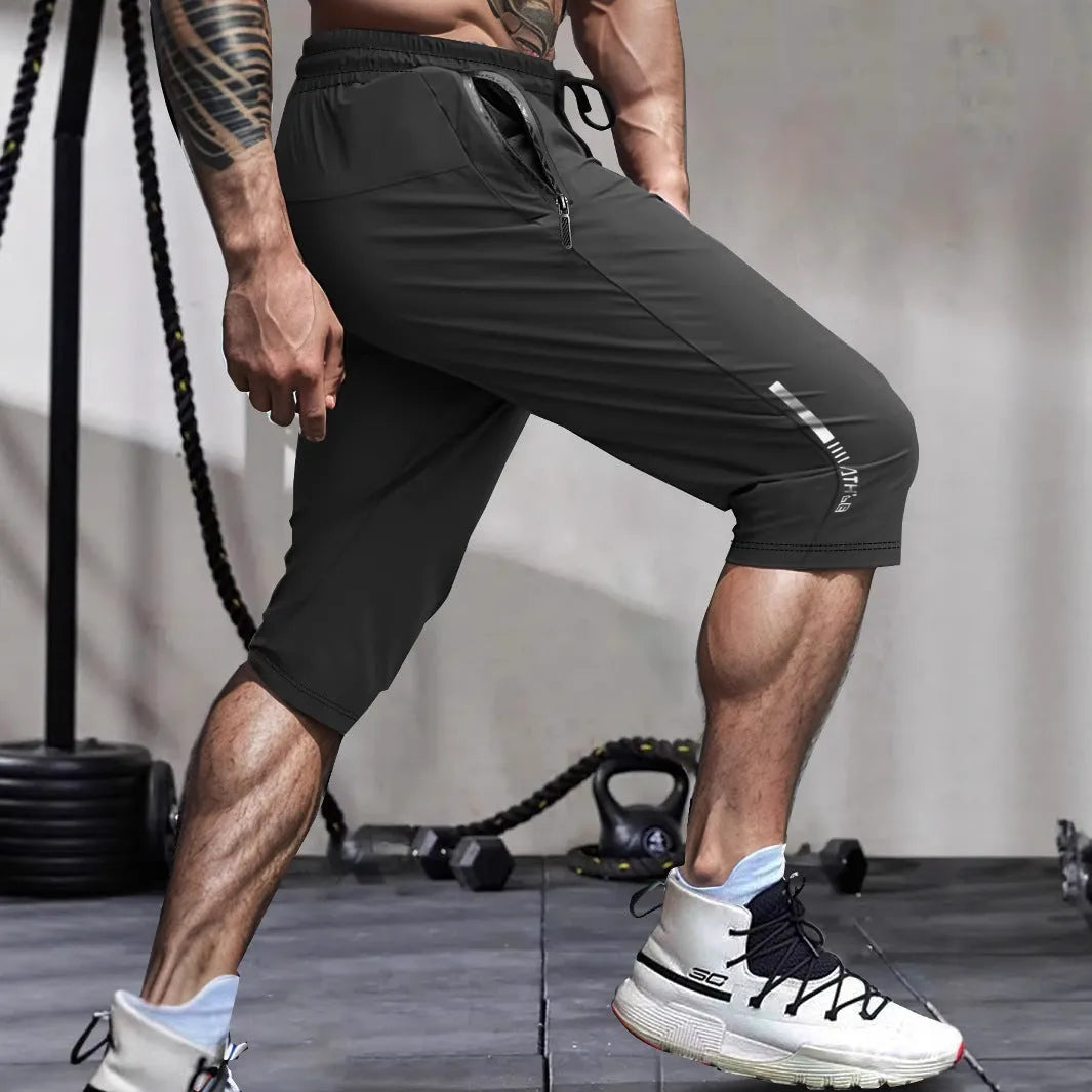 Men's black cropped sports pants with straight-leg cut and quick-drying nylon fabric