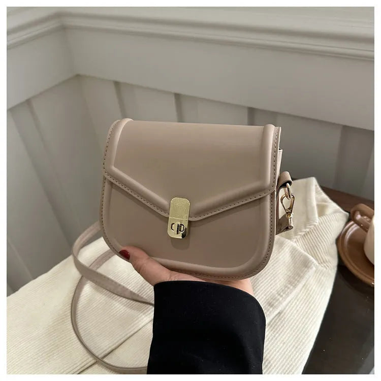 Soft PU leather clamshell messenger bag in a horizontal square shape on a shoulder strap.