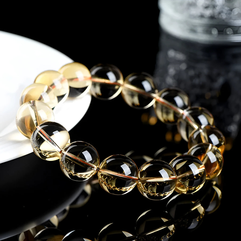 Natural golden citrine bead bracelet with scattered design on a wrist, showing adjustable clasp and polished stone detail.