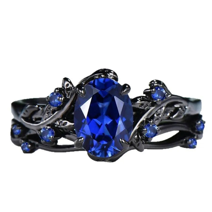 Geometric gun black couple ring for women with a single inlaid navy blue rhinestone.