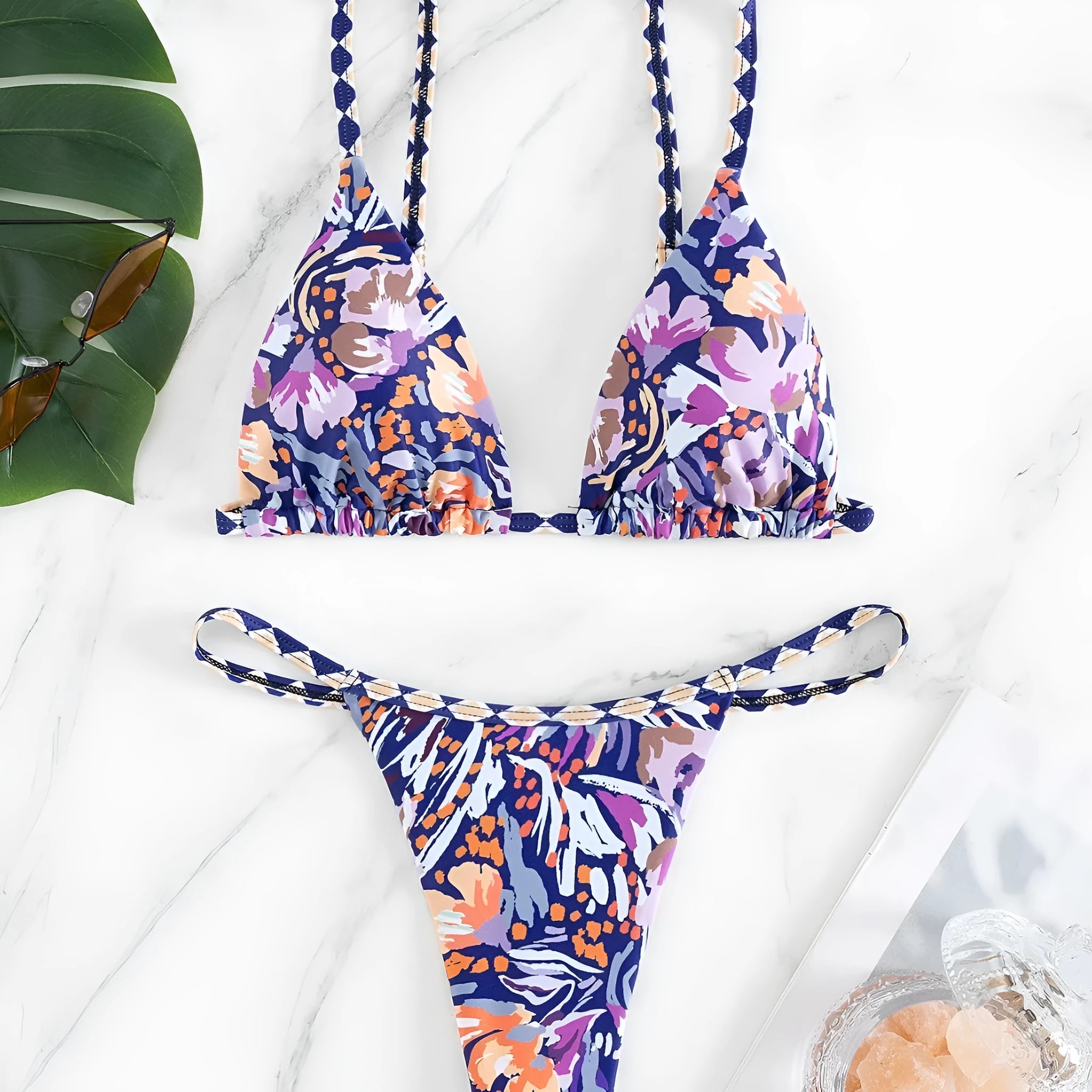Women's floral print triangle bikini swimsuit with adjustable tie sides on white background