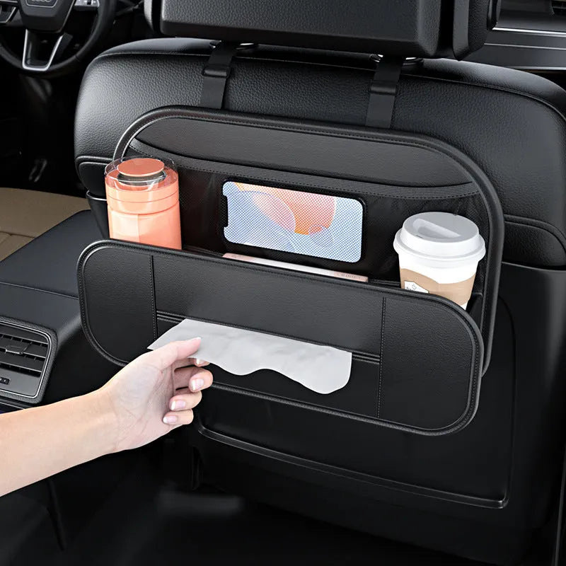 Black leather car seat rear storage bag with compartments, shown mounted on a car seat.