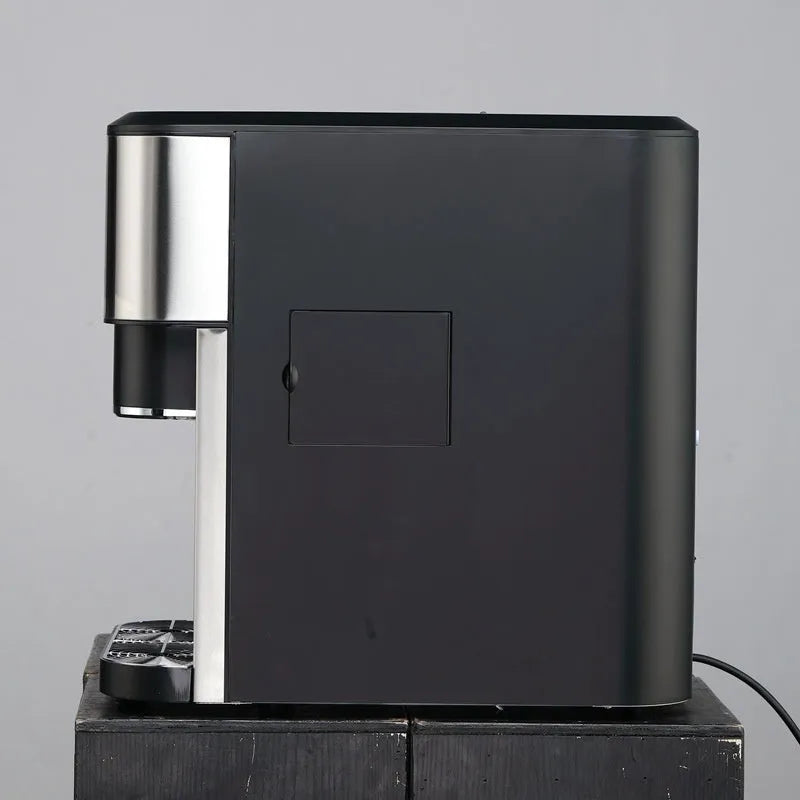 Black desktop ice maker with stainless steel accents on a kitchen countertop