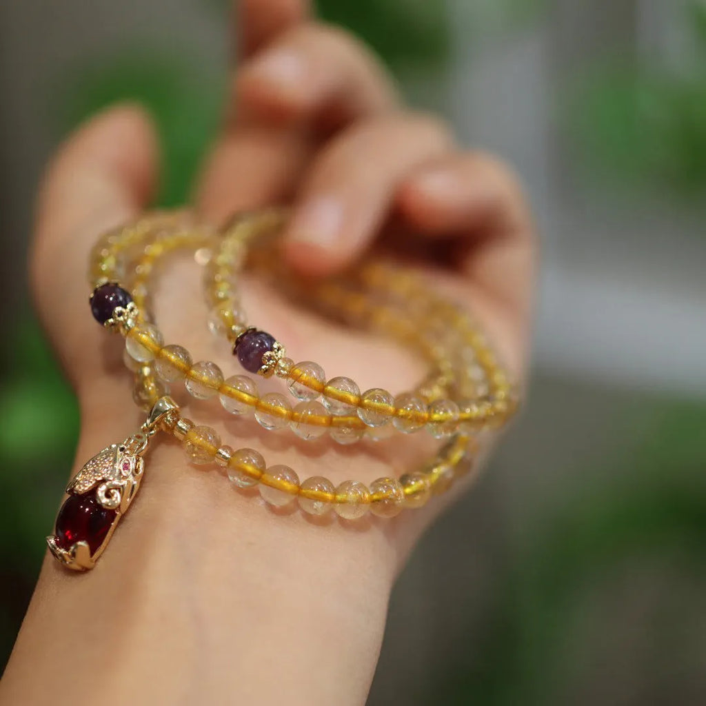Natural Brazil gold rutilated quartz bracelet with three circular accents and Chinese-style hanging chopsticks design