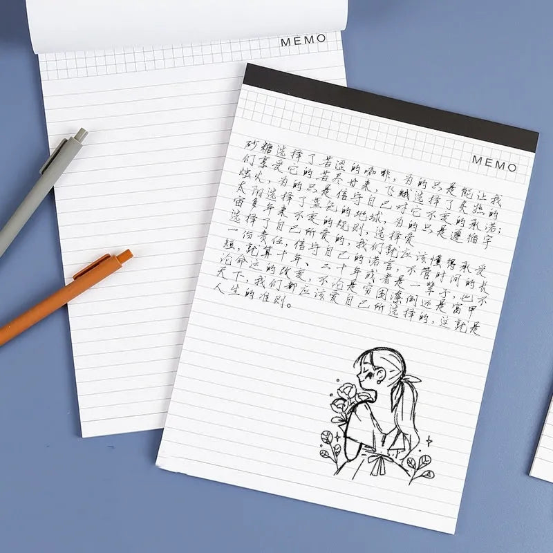 A4 tearable notebook with soft cover open to show gridded ivory white paper inside.