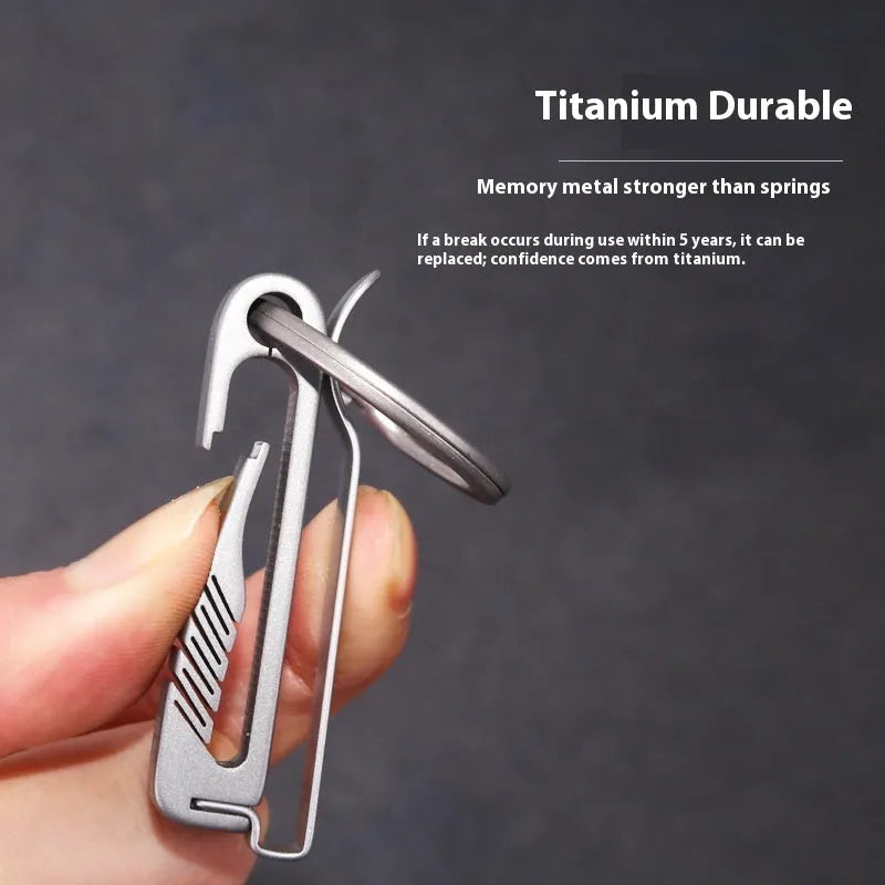 Titanium alloy key ring pendant with black buckle belt attachment, shown in sizes 9mm, 13mm, 17mm, and 21mm