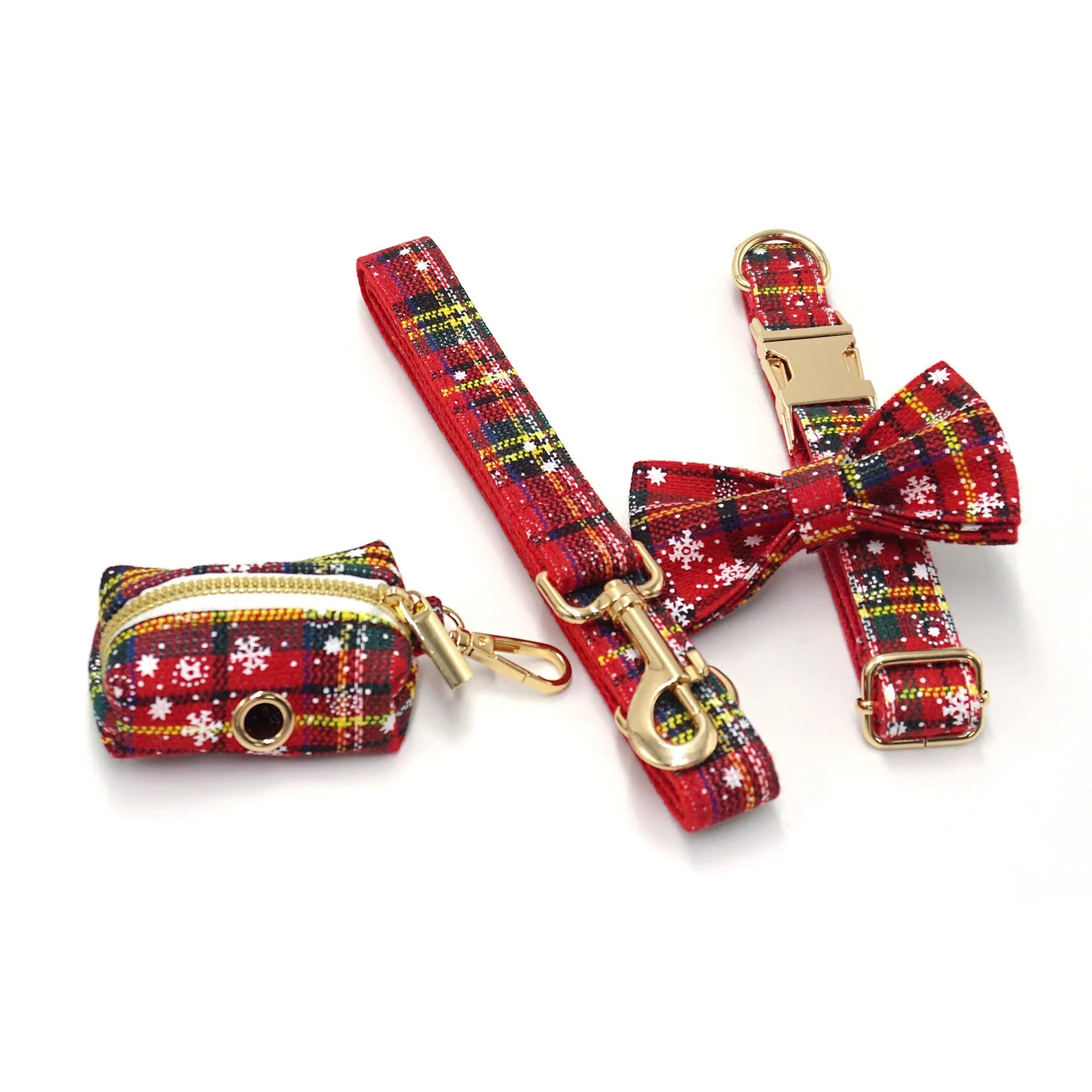 Red Christmas pet collar set with matching harness, leash, bow, and dog waste bag on cloth background
