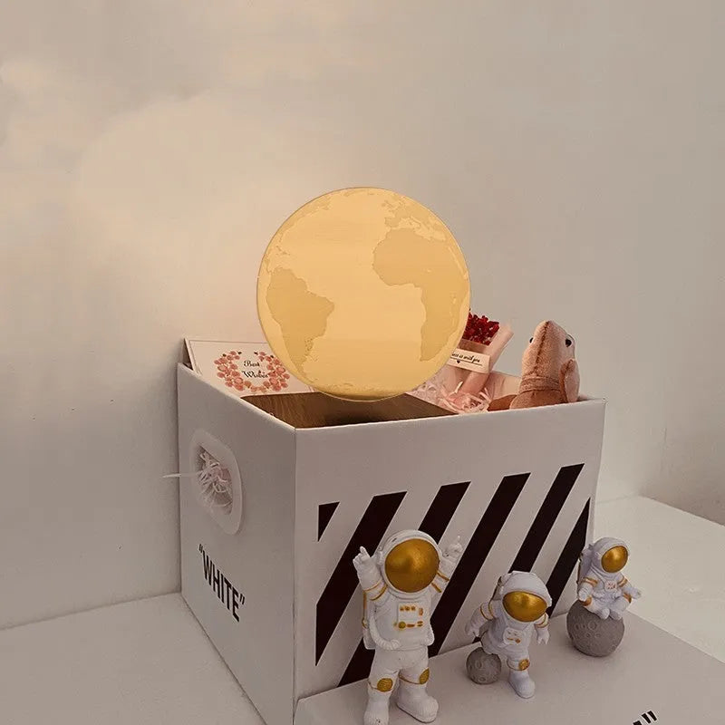 Maglev moon and planet night light floating above base with three astronaut figurines