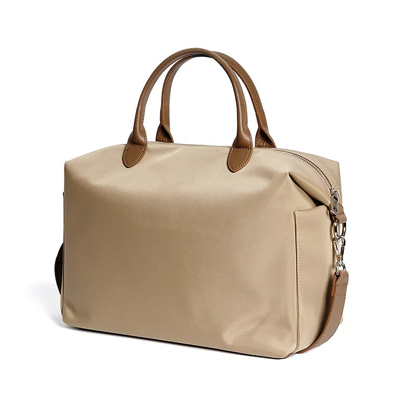 Black waterproof nylon shoulder bag with leather detailing showing large main compartment