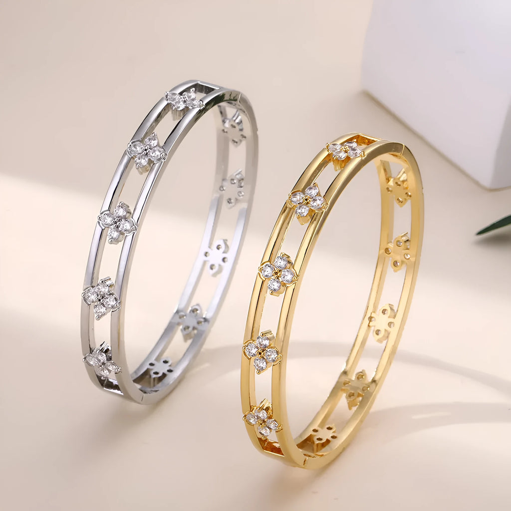Hollow women's bracelet with four-leaf clover charm containing inlaid AAA zircon gemstones